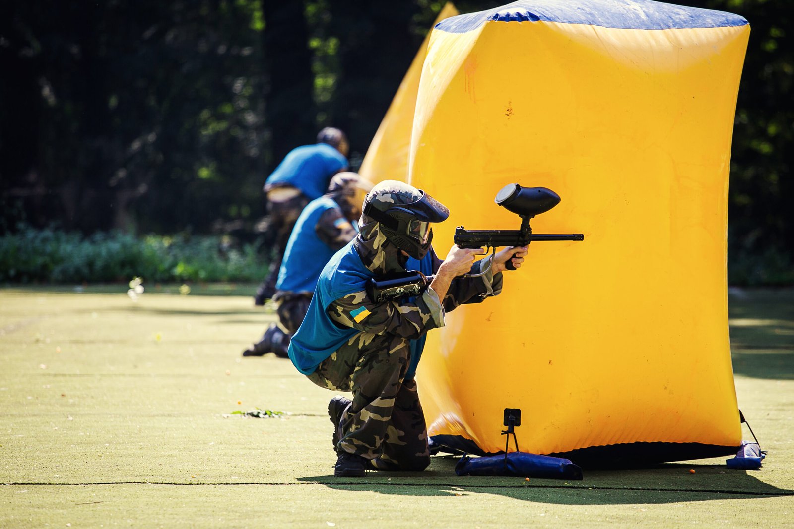 Vinnitsa,Ukraine - August 22,2016.Young man (Paintballer)in protective uniform and mask in extreme process of paintball game